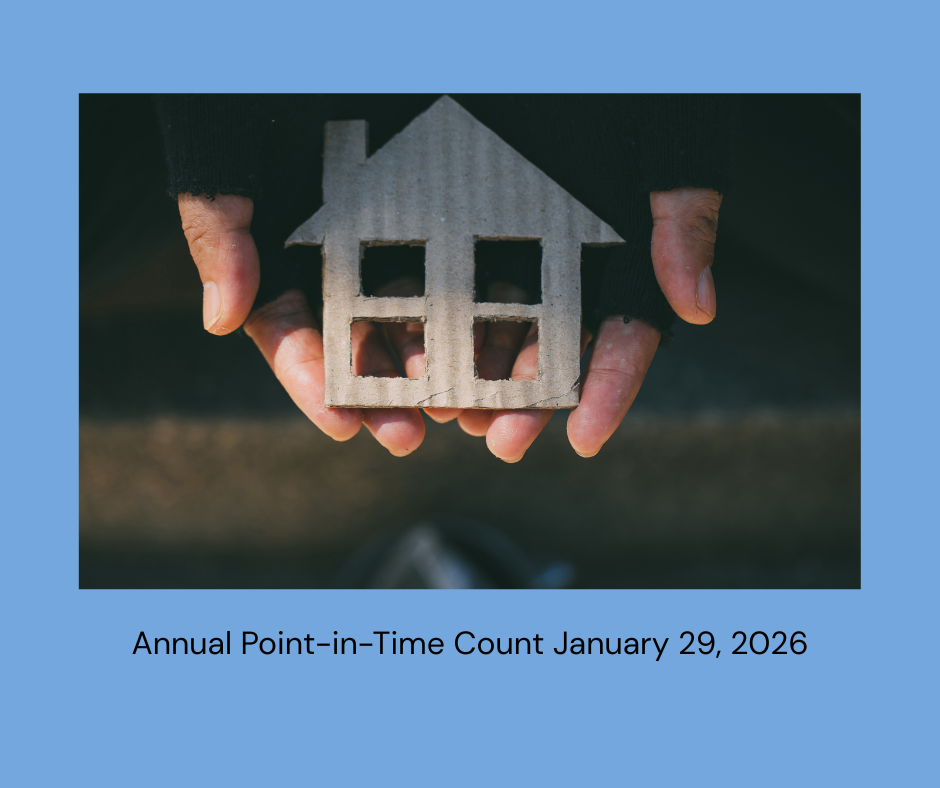 Hands holding a small carboard cut out of a house 