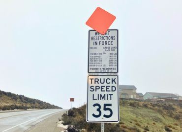 Photo of a weight restriction sign with the flag raised