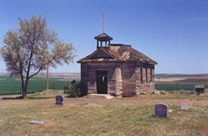 Open space with a historical building and grave stone markers