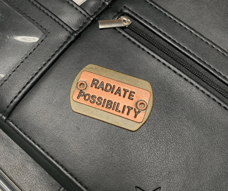 Close up of a small metal keepsake with the words 